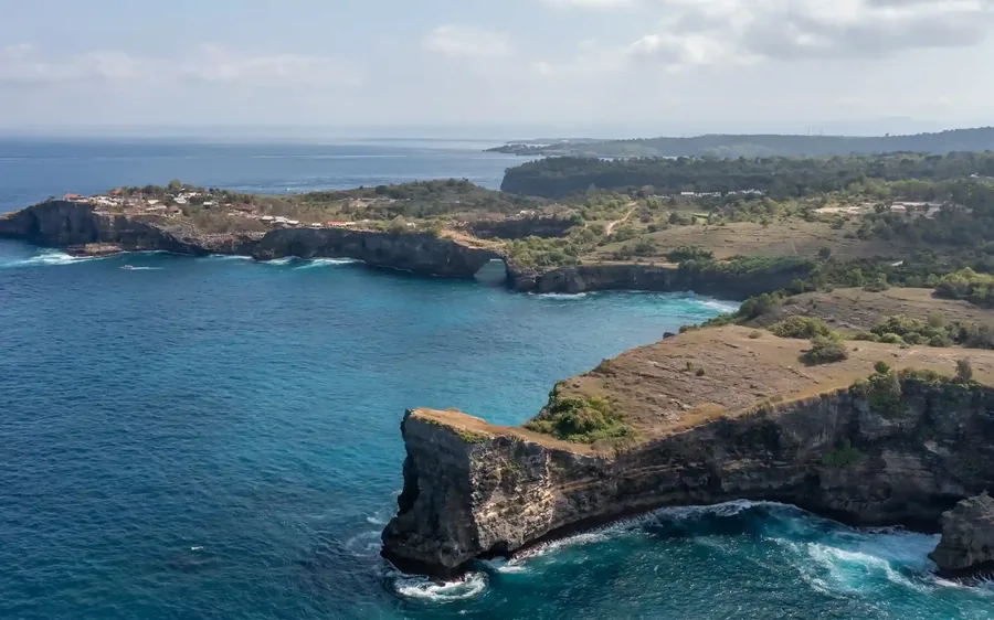 Limestone cliffs above clear water on the Bali coast