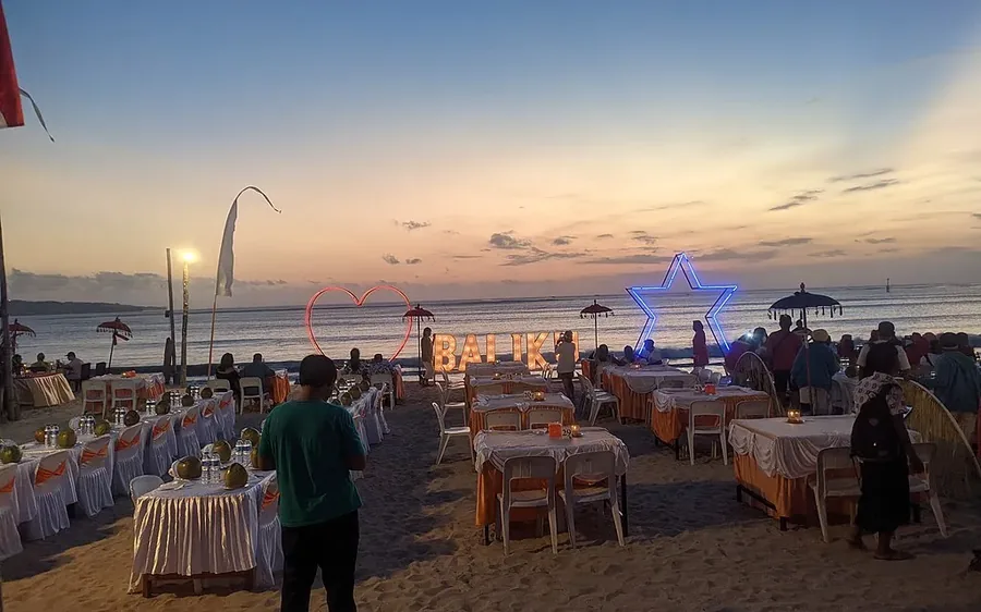 Beachfront dinner tables set on the sand at Jimbaran Bay