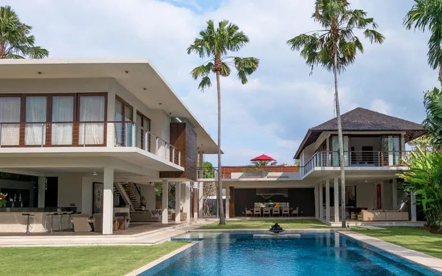 Bali villa with a private pool and palms at the edge of the lawn