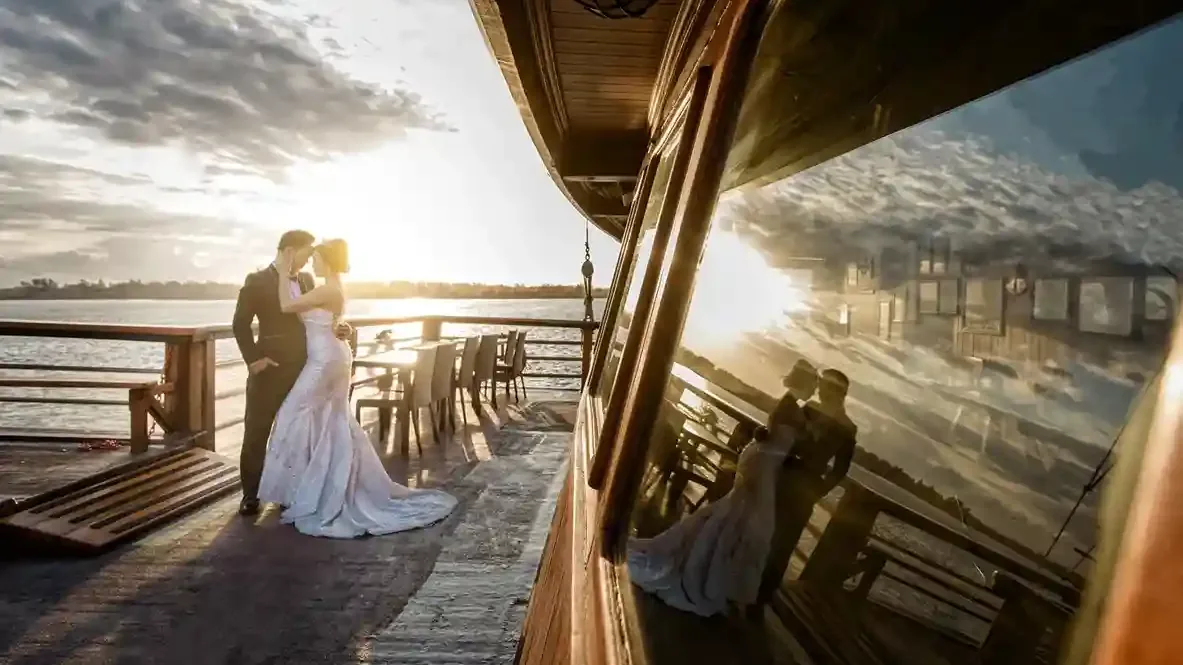 Couple on the deck of a traditional phinisi at sunset in Bali